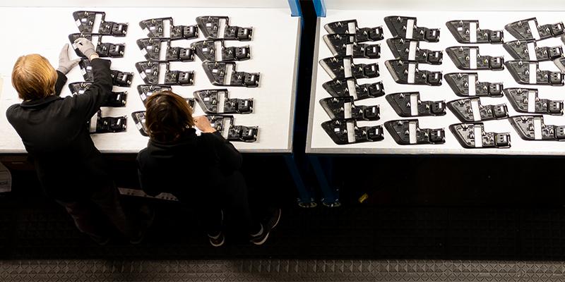 Overhead view of employees working on parts