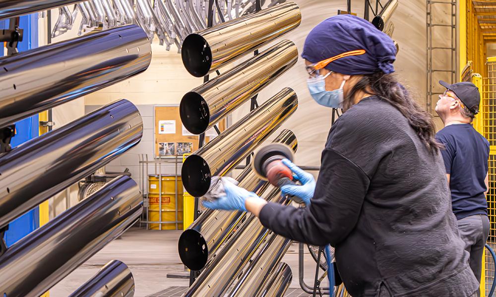 Employees polishing parts on a line