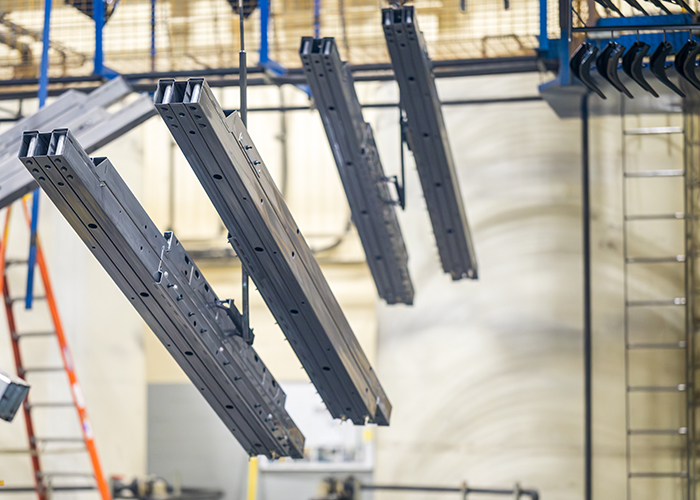 Long metal parts on a line waiting to be electrocoated