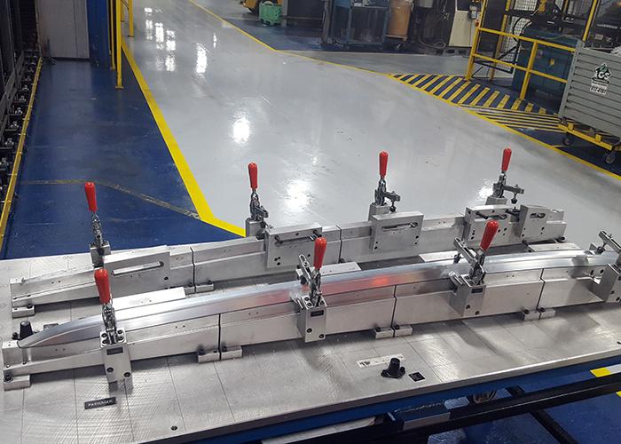 Metal mold on table held together with clamps